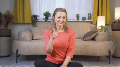 Blonde Woman Sitting and Giving Thumbs Up