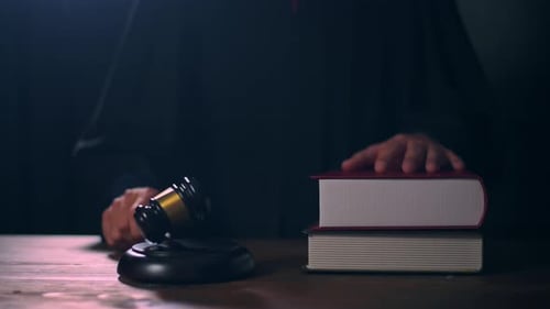 Close up of Judge hand is hitting hammer judge in courtroom