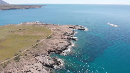 Aerial beautiful beach and water bay in the greek spectacular coast line. Turquoise blue transparent