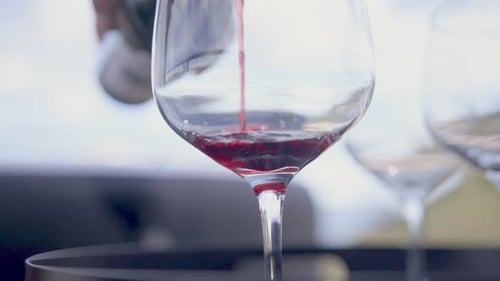 Pouring Red Wine into a Glass