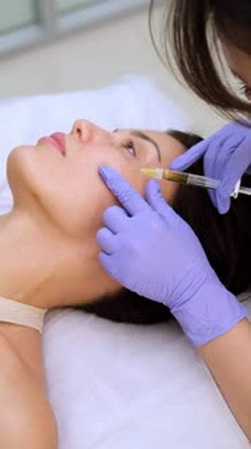 Woman receives beauty injection for face rejuvenation