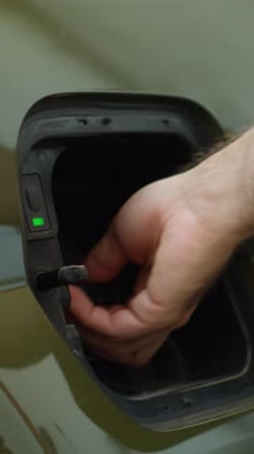 Vertical Video Close Up Shot of Driver Recharging EV Vehicle Battery Powering Electric Motor
