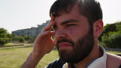 Sleepy Boy Wakes Up After A Nap On A Park Bench