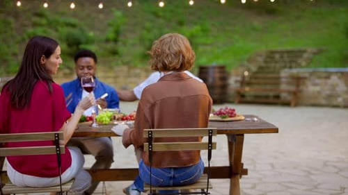 Friends Enjoying Outdoor Meal Together