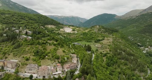 Aerial view of town nestled in mountains, Italy.