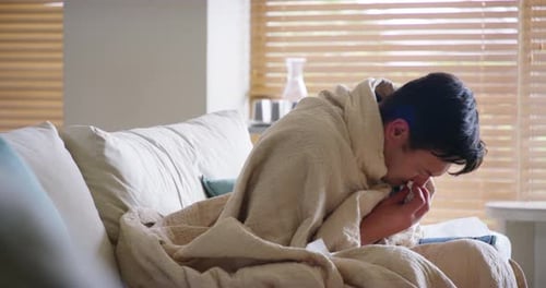 Man Suffering from Cold and Blowing Nose