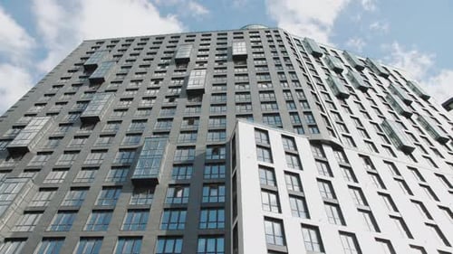 Skyscraper with Numerous Windows Against a Clear Blue Sky