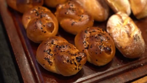 Various varieties of soft, caramelized bread are on exhibit. This common snack is made from a dough