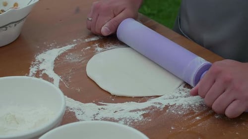 Chef Rolls Out Dough with Rolling Pin