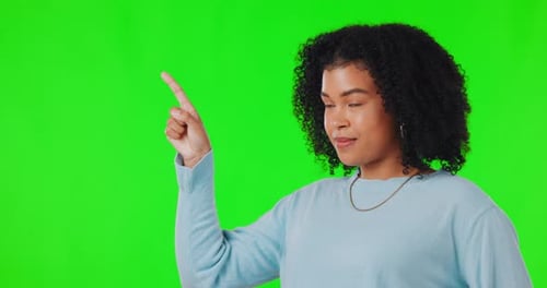 Woman, pointing finger and green screen for advertising space, announcement or promotion