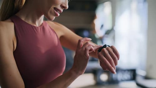 Woman Athlete Checking Smartwatch Standing in Gym Closeup Sportswoman Smiling