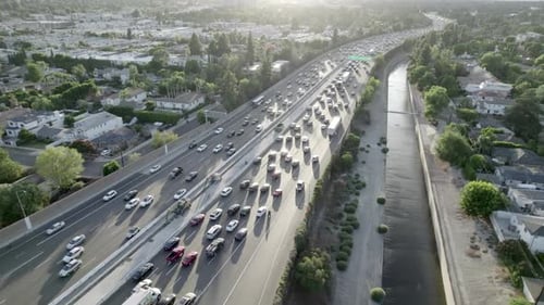 Freeway rush hour traffic of car, sunset in Los Angeles, aerial above