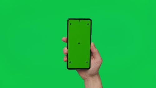 Male Hand Holding a Smartphone with Vertical Green Chroma Key Screen Isolated on Green Mobile Phone