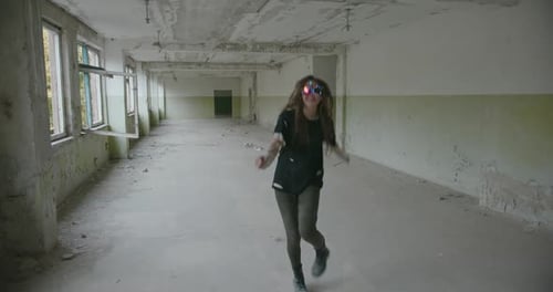 Woman with Goggles Smiles in Abandoned Building