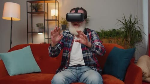 Senior Man Experiencing Virtual Reality Headset in Living Room