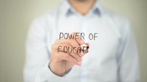 Man Writes Power of Education on Clear Surface
