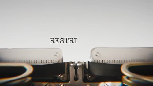 Old mechanical typewriter typing Restricted Access in a close-up view.