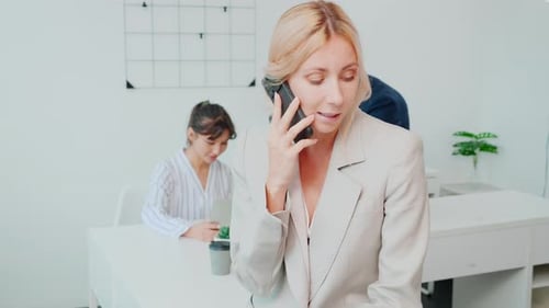 Woman Talking on Phone in Bright Modern Office