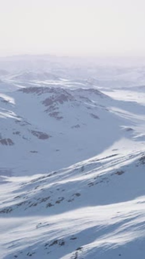 A Breathtaking Aerial View of Snowcovered Mountain Peaks