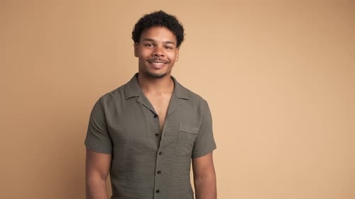 Smiling Young Adult Portrait on Beige Backdrop