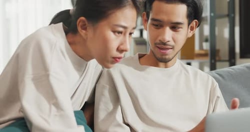 Young Couple Using Laptop Together at Home