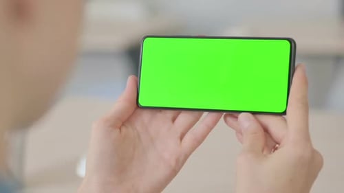 Close Up of Young Woman Holding Smartphone with Green Screen
