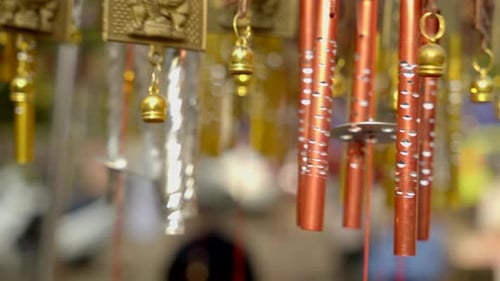 Close-up wind Chimes hangs on the porch of the house. Group of wind Chimes hanging on a festival