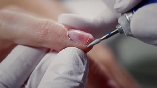 Manicurist Uses an Electric Machine to File the Nails Nail Art Master Prepares Fingers for Polish