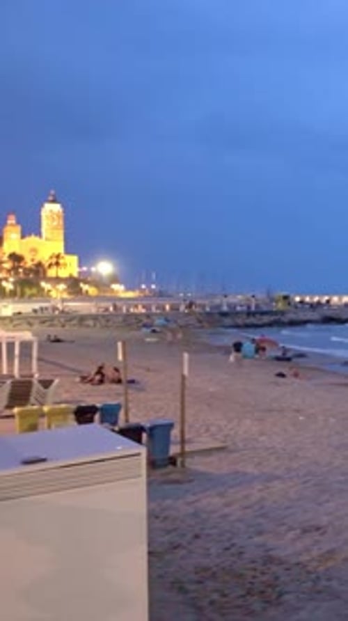 People Relaxing on the Beach in Sitges at Night