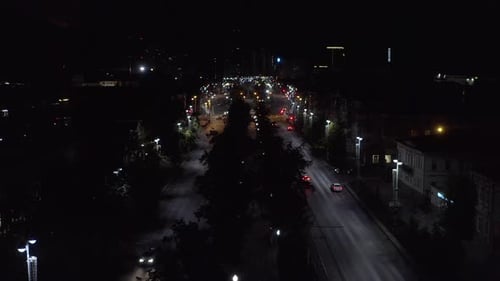 Beautiful view of highway with cars and lanterns. Night road in the center of modern city