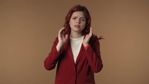 Worried Woman Blocking Ears in Studio