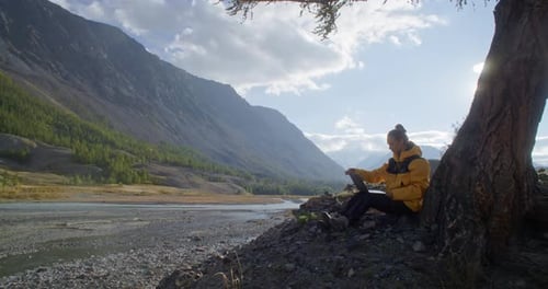 Enjoy Remote Work in Nature Using a Laptop While Surrounded By a Stunning Mountain View