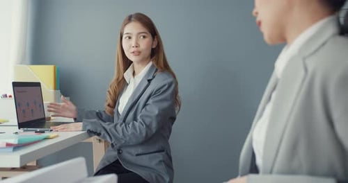 Group of asia discuss project compare point in paperwork and laptop on table working.