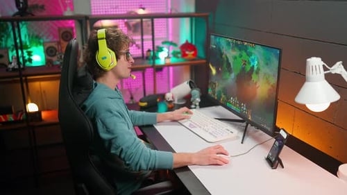 Young Adult Gamer Playing Computer Game