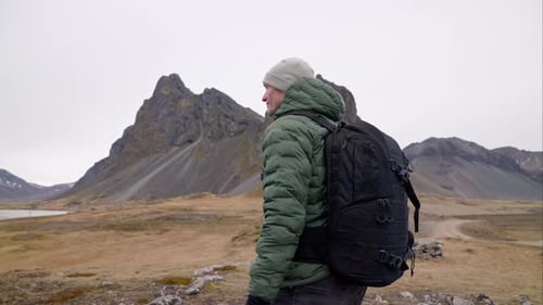 Man in Backpack By Eystrahorn Mountain