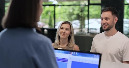 Hotel Manager Giving Tourist Woman Key Card at Hotel Desk Concierge Service Woman Smile in Lobby for