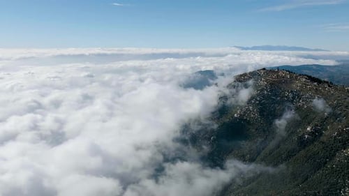 Aerial View of Mountain Partially Obscured by Clouds