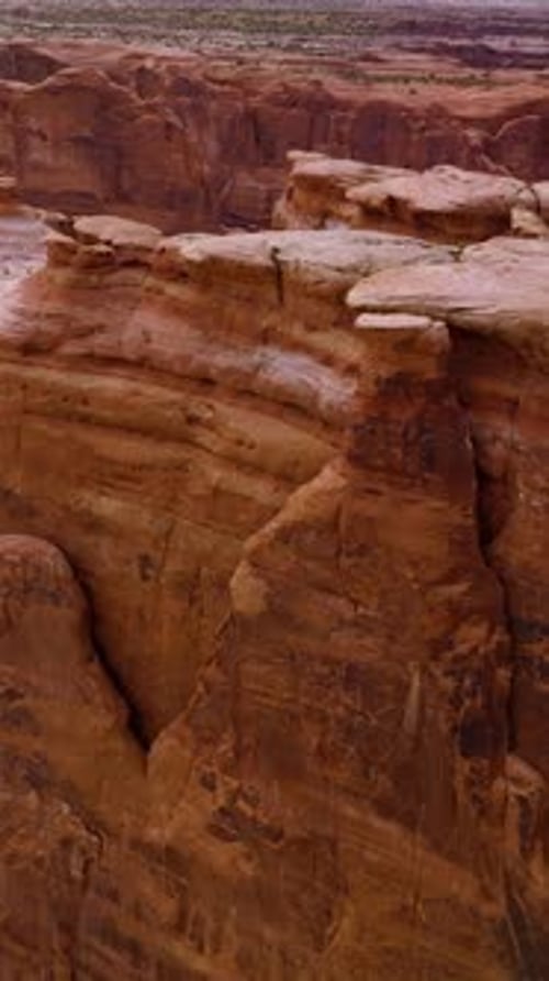 Rounded peaks and tops of orange mountains. Drone footage over the rocks in Arches National Park