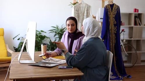 Two Women Working at a Desk in Office