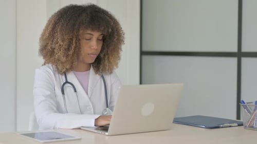 African Female Doctor Looking at Camera at Work in Clinic