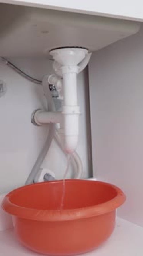 Vertical Footage of Water Leak Under Kitchen Sink