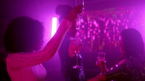 Women Toasting Champagne at Nightclub Celebration