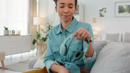 Woman Puts On Headphones And Listens To Music