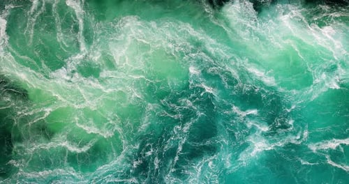 Blue waves of water of the river and the sea meet each other during high tide and low tide.