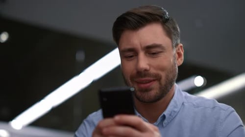 Business Man Text Mobile Phone Chat Online In Corporate Workplace. Close Up Smiling Ceo Working U...