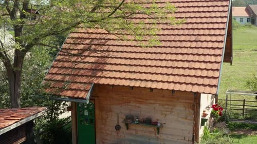Tiny Wooden Cabin Outside The City - aerial descend