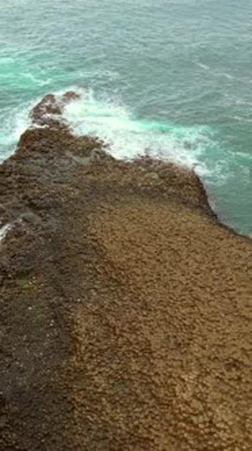 Rotating social ratio aerial video of The Giant's Causeway in Bushmills, Northern Ireland