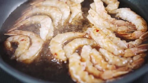 Langoustines in Sauce Cooking Process Slow Motion View of Shrimps in the Frying Pan Seafood