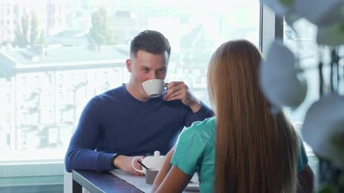 Man and Woman Having Tea in Cafe