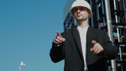 Young Engineer Gesturing Towards the Future